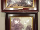 two paintings hanging on the wall of a room