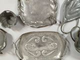 several pieces of silverware sitting on a white surface