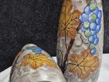 two vases that are sitting on a table