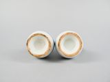 pair of blue and white porcelain vases on a gray surface