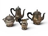 three pieces of silver tea and coffee set on a white background
