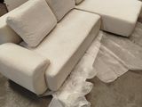 a couch that has been wrapped up and is in the process of being painted