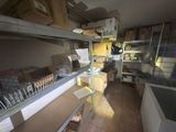 a room filled with boxes and shelves with boxes on them