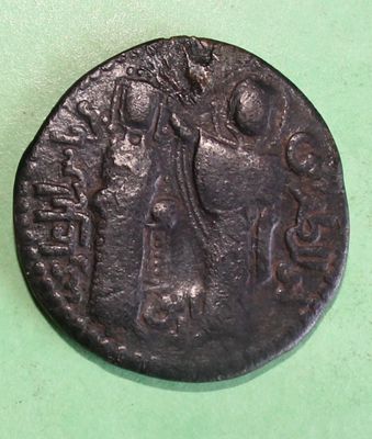an old coin with a woman holding a child on it