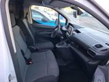 the interior of a small car with black seats and a steering wheel