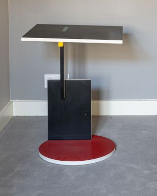 a black and red table with a red base