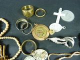a lot of jewelry that is laying out on the table