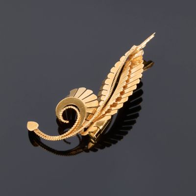 an image of a gold plated brooch with a leaf design on it