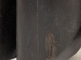 two black vases sitting next to each other on a white surface