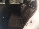 the back seats of a white car with a black seat belt