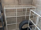 a metal cage with a tire in the corner of a room