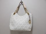 white michael korsh handbag hanging on a hook on a wall