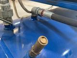 a close up of a blue tank with a hose attached to it