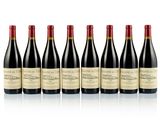 six bottles of red wine lined up in a row