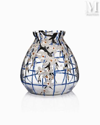 a glass vase that has a blue and white design on it