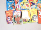 several children ' s books are lined up on a white surface