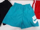 three pairs of men ' s nike shorts on a white surface