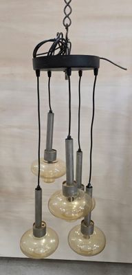 a chandelier with five lights hanging from it ' s ceiling