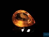a yellow diamond on a black surface