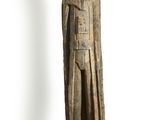 a wooden statue of a man with a helmet and cloak