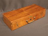 a small wooden box with a handle on a table