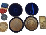 several medals and medals are in a case on a white surface