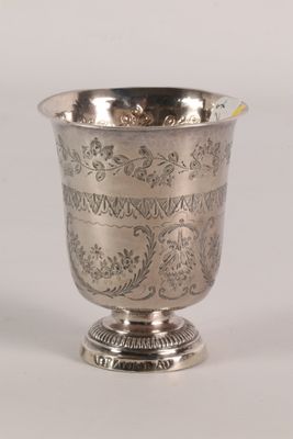a silver cup that is sitting on a table