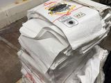 a stack of white bags sitting on top of a wooden table