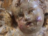 a statue of an angel holding a baby in its arms