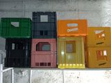 many different colored plastic containers lined up on a table