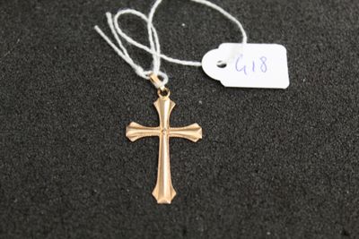un gros plan d'une croix suspendue à un cordon, avec une étiquette de prix