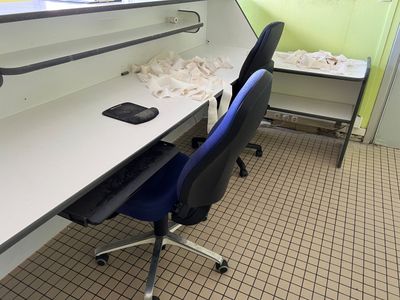 a desk with a chair and a computer on it