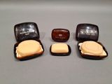 three soap bars in a case on a table