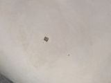 a close up of a silver plate on a tiled floor