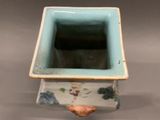 a blue and white vase with a bird on it