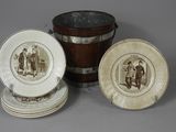 three plates and a bucket with a picture of a man and a woman on them