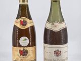 two bottles of wine sitting next to each other on a white surface