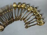 a lot of silver spoons and forks arranged in a circle