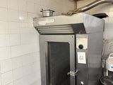 an image of a commercial kitchen with a stove and oven