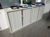 a white cabinet that has a bunch of papers on top of it