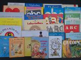 many children ' s books laid out on a black surface