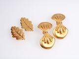 three gold tone earrings and a leaf brooch