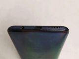 the back of a cell phone with a blue back and a black back