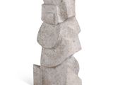 a stone statue that is sitting on a white surface