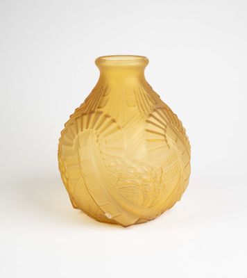 a yellow vase that is sitting on a white surface