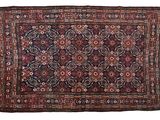 an antique persian rug with a floral design and fringe fringes