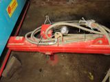 an image of a red machine with a hose attached to it ' s side