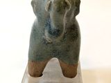 a small vase with an elephant on top of it