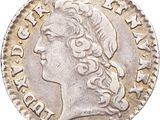 gros plan d'une pièce de monnaie sur laquelle figure une tête de femme