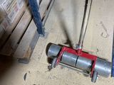 a picture of a pipe clamp on the floor next to a pallet
